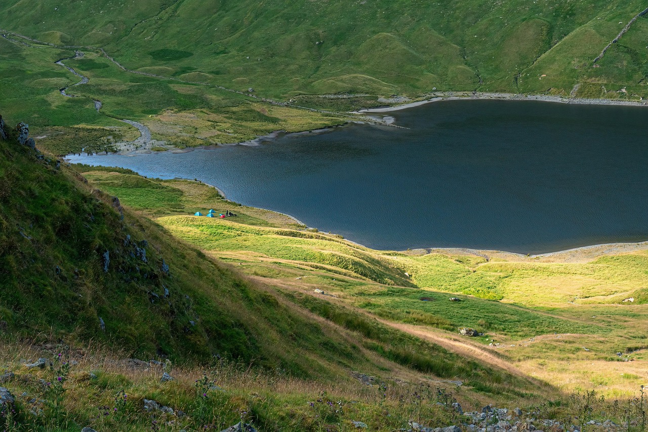 Tentes installées au bord d'un lac de montagne, camping nature économique